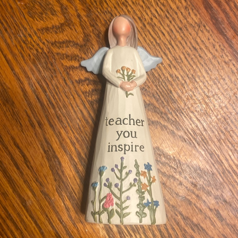 Angel figurine that says teacher you inspire with flowers at the bottom